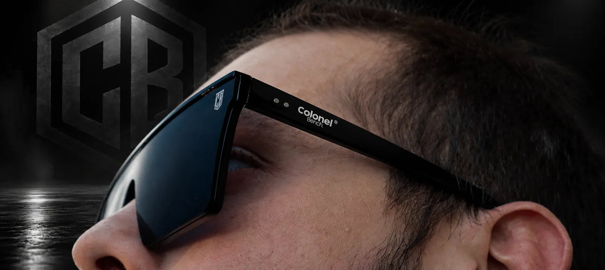 Close-up of CB Mask shield sunglasses with the CB crest and Colonel Bench logo on the arm